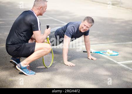 Mature men doing push-ups Stock Photo