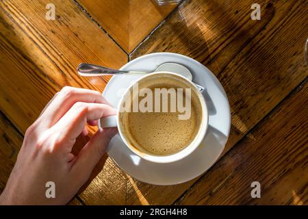 Woman's hand holding cup of coffee Stock Photo