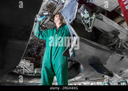 Man working on airplane Stock Photo