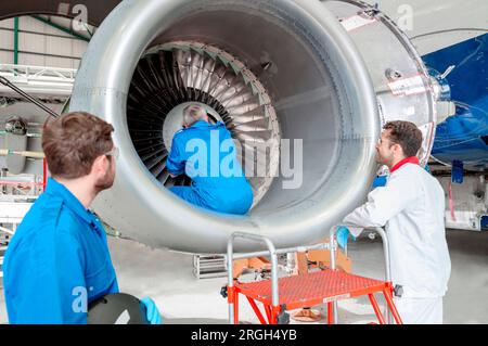 Men working on airplane engine Stock Photo