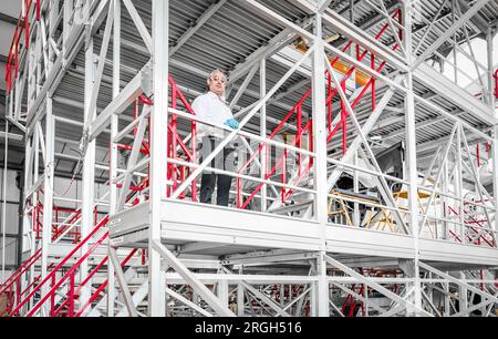 Man wearing safety equipment on staircase Stock Photo