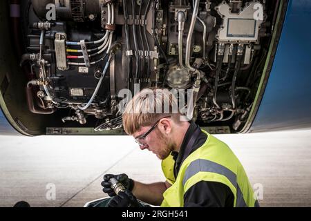 Man working on airplane Stock Photo