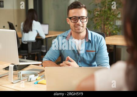 Smiling young man during meeting Stock Photo