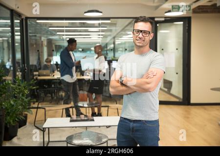 Smiling young businessman in office Stock Photo