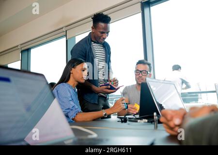 Colleagues using laptops during meeting Stock Photo