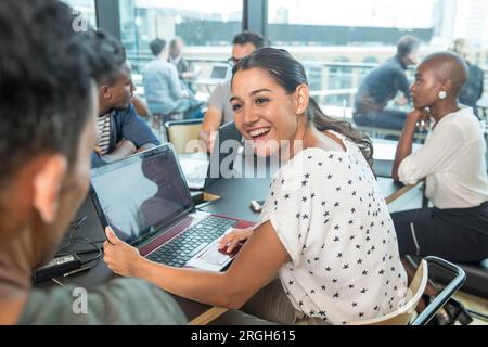 Colleagues using laptops during meeting Stock Photo