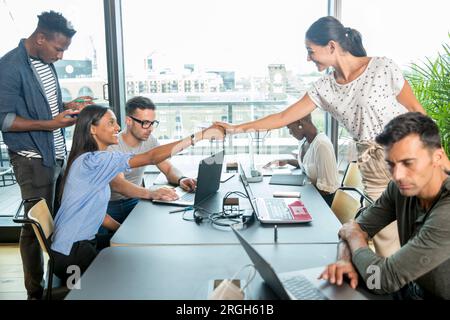 Businesswomen shaking hands during meeting Stock Photo