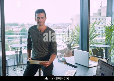 Businessman holding digital tablet in conference room Stock Photo