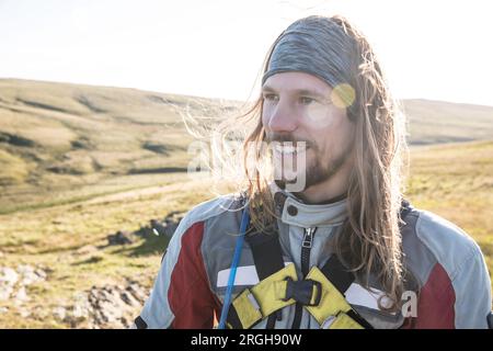 Portrait of young man smiling in field Stock Photo
