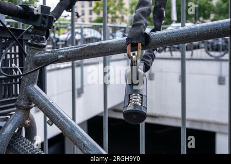 A bicycle secured with a combination lock Stock Photo