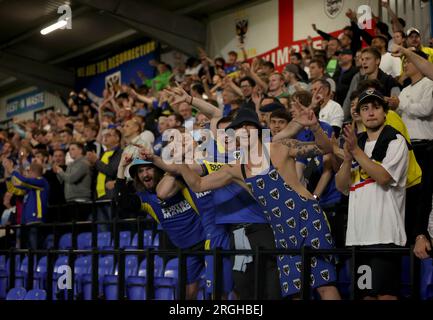 AFC Wimbledon fans show their support in the stands during the Carabao Cup first round match at the Cherry Red Records Stadium, London. Picture date: Wednesday August 9, 2023. Stock Photo