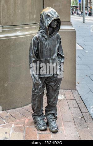 Youngsters - child sized bronze statue of young urchin boy wearing a hoodie in George Street, Sydney, Australia on 7 January 2023 Stock Photo