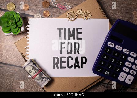 The text TIME FOR RECAP appearing on yellow paper behind torn color paper Stock Photo