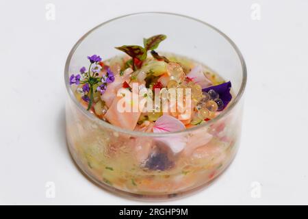 salmon ceviche in a glass dish with white background Stock Photo