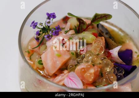 salmon ceviche in a glass dish with white background in close up Stock Photo