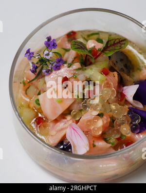 south american salmon ceviche in a glass dish with white background in close up Stock Photo