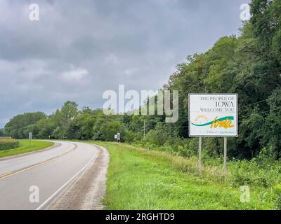 Iowa welcome roadside sign at state border with Nebraska, summer scenery, travel concept Stock Photo
