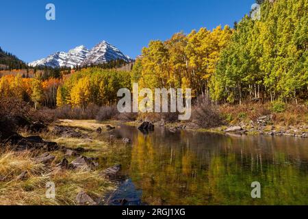 Maroon Bells reflected in a stream near Aspen in autumn, Maroon Bells-Snowmass Wilderness, Colorado Stock Photo