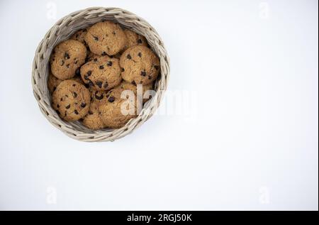 Chocolate chip cookies in a bamboo basket isolated on white background Stock Photo