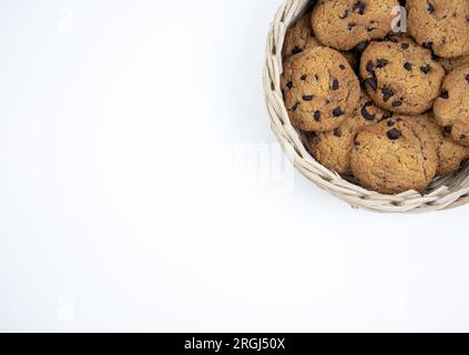 Chocolate chip cookies in a bamboo basket isolated on white background Stock Photo
