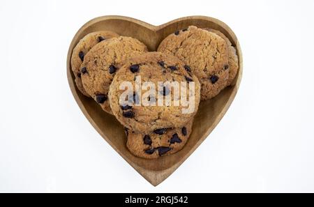 Chocolate chip cookies on a heart shaped plate on a white background Stock Photo