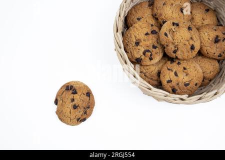 Chocolate chip cookies in a bamboo basket isolated on white background Stock Photo