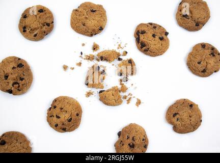 Chocolate chip cookies with focus on crushed chocolate chip cookies in the middle on white background Stock Photo