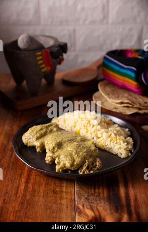 Pipian, also known as mole verde, food from mexico and other latin american countries, chicken meat bathed in mole sauce made with pumpkin seeds, drie Stock Photo