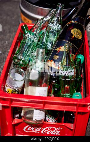 Empty Coca-Cola bottles and other bottles in a red Coca-Cola plastic crate; Japan Stock Photo