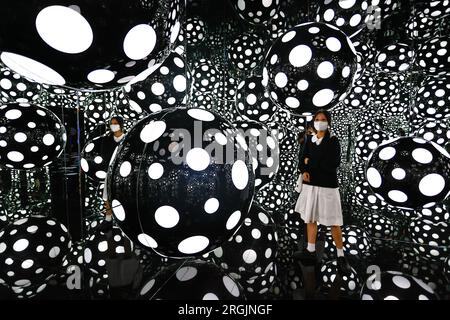Hong Kong. August 10, 2023, Hong Kong, Hong Kong, Hong Kong: A lady visits art installation ''” DOTS OBSESSION ''“ ASPIRING TO HEAVEN'S LOVE, at M Visual Culture Museum in The artwork by Japanese artist Yayoi Kusama, who has lived in the United States between 1958 and 1975, features her famous polka dots and reflective mirrors inside a cubic environment which offers a kaleidoscopic visual experience. (Credit Image: © Daniel Ceng Shou-Yi/ZUMA Press Wire) EDITORIAL USAGE ONLY! Not for Commercial USAGE! Credit: ZUMA Press, Inc./Alamy Live News Stock Photo