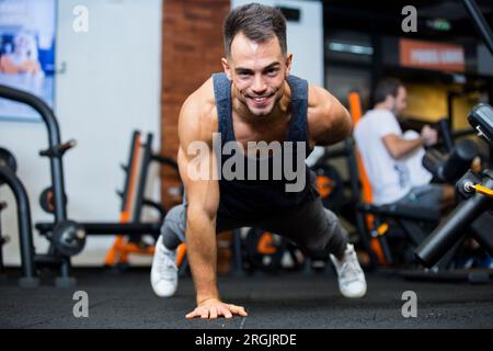 young man doing pushups with one hand Stock Photo