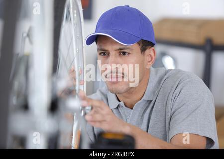 man fitting light to bicycle Stock Photo