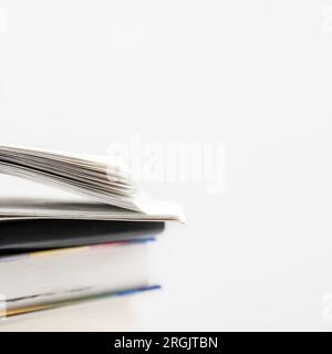 Books collection in pile and one of them open on top. Education concept. Stock Photo