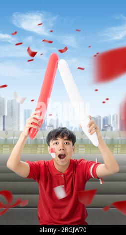 Indonesian man supporting the team when competing. Indonesian independence day Stock Photo