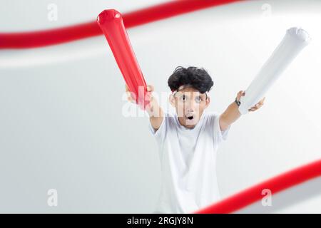 Indonesian man supporting the team when competing. Indonesian independence day Stock Photo