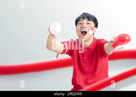 Indonesian man supporting the team when competing. Indonesian independence day Stock Photo