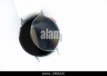 Replacement of cracked glass on a smart watch on a white background, repair Stock Photo