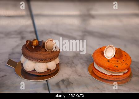Orange and White Macarons on Marble Table Stock Photo