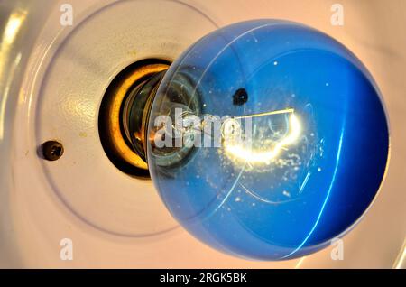 Wide angle close-up image of blue incandescent light bulb Stock Photo