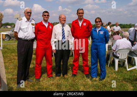 Second World War veteran RAF pilot Wg Cdr Peter Ayerst DFC at Biggin Hill flanked by Royal Air Force Red Arrows pilots and PRO Emma Thomas (L) Stock Photo