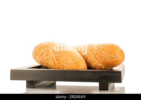 Two delicious fragrant rolls on a black wooden tray, close-up, isolated on white. Stock Photo