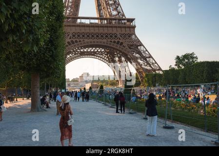 Sunset Stroll in Front of Eiffel Tower Stock Photo