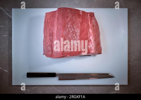 Shot of uncooked fresh red tuna piece on kitchen table Stock Photo