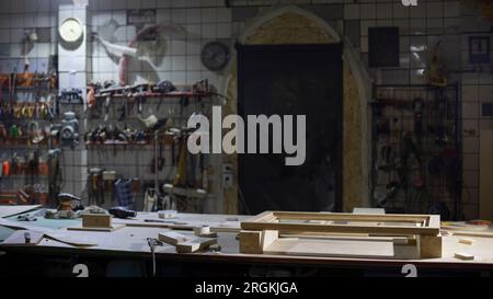 Items in garage. Workplace for creating structure. Production shop. Working tools on table. Stock Photo