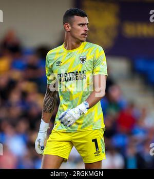 AFC Wimbledon Nik Tzanev in action during the Carabao Cup first round match at the Cherry Red Records Stadium, London. Picture date: Wednesday August 9, 2023. Stock Photo