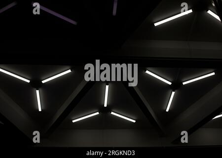 Triangular fluorescent lamps. Ceiling design. Interior details ...