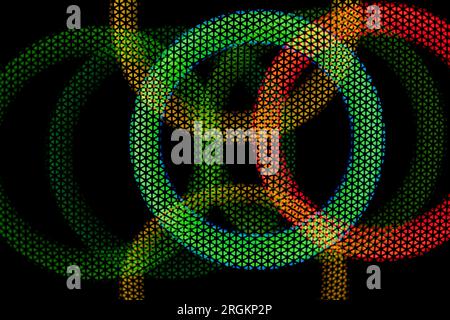 Texture green and red circles in grid on dark background. Glow in dark. Abstract disco background. Colored light. Circles intersect. Stock Photo