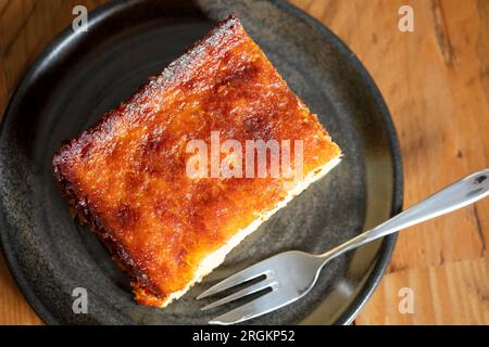 A serving or slice of Orange Pie. This is a Greek specialty known as Portokalopita. Its made with phyllo pastry and soaked in an orange syrup Stock Photo