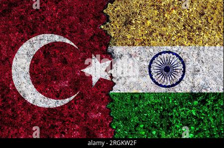 Turkey and India painted flags on wall with grunge texture. Turkey and India conflict. India vs Turkey Stock Photo