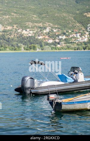 A modern and old boat with engine in a lake on sunny day Stock Photo